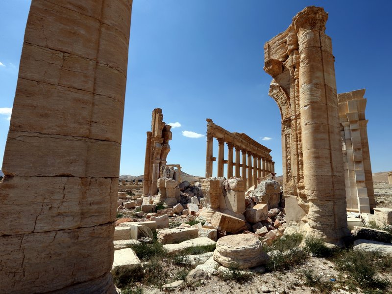 The remains of the Arch of Triumph, shown here in a March 31 photo, stand in the ancient Syrian city of Palmyra, a World Heritage Site. The arch and other monuments were destroyed by ISIS last year. Joseph Eid/AFP/Getty Images